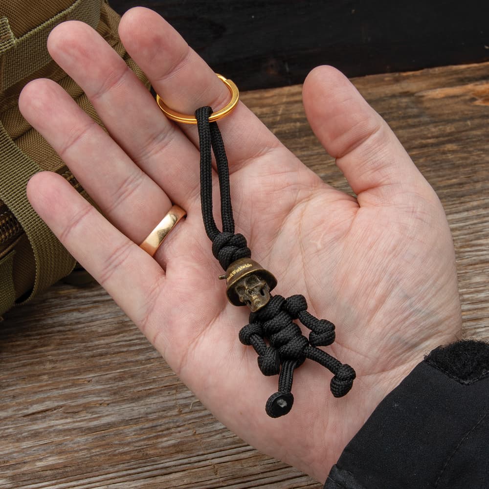 Full image of the Trooper Pendant Keychain held in hand connected to a keychain. image number 2